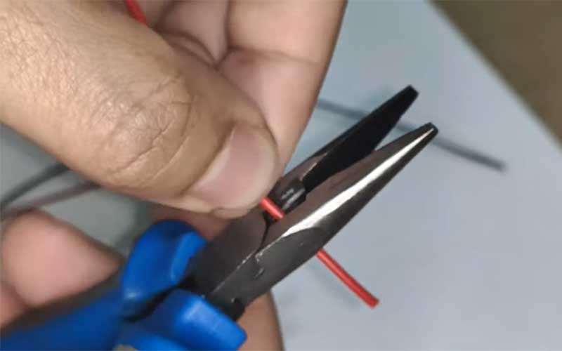 strip off a wire using a pliers
